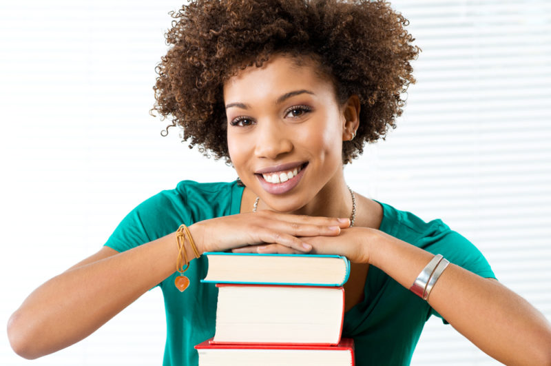 woman with hardcover books - deposit photos